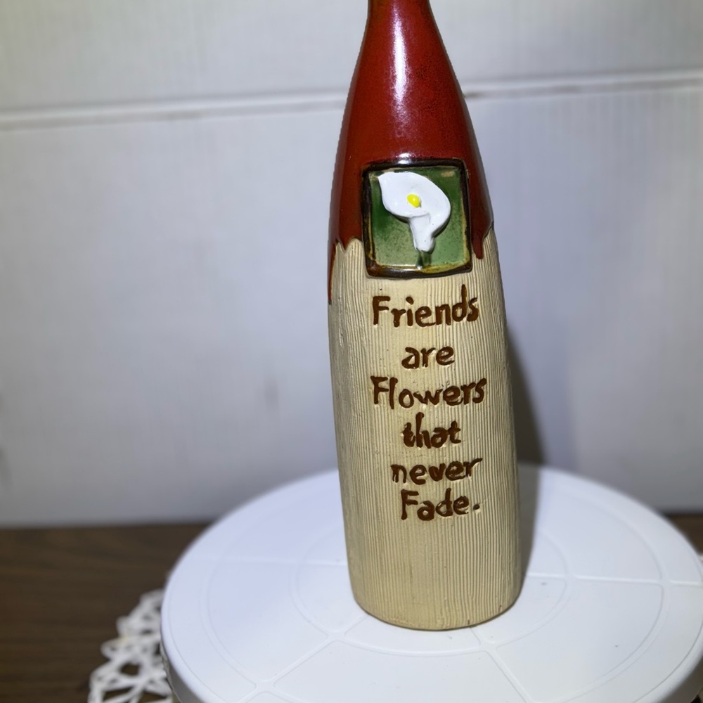 decorative bottle. Features a floral design. Inspirational quote on the front.